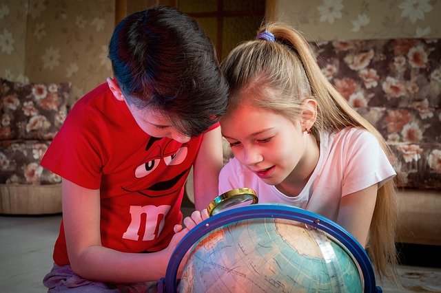 Kids learning with an atlas
