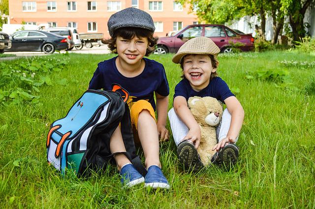 Kids with a travel backpack, an important road trip essential for kids 