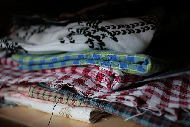 spread clothes to organize - travel packing tips