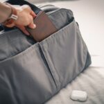 travel essentials for men packed in a suitcase